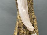 a mannequin mannequin wearing a yellow dress with black and white flowers