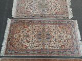 two rugs with fringes on them are sitting on the floor