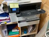 une imprimante posée sur un bureau dans un coin de la pièce