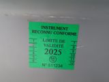 a green sticker on the side of a white refrigerator