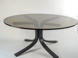 a black table with a glass top on a white background
