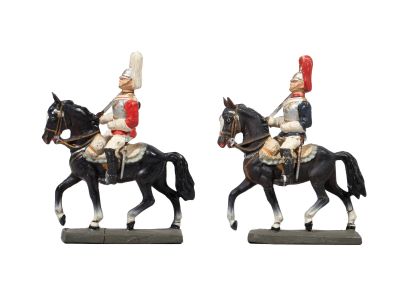 two figurines of two men on horses on a white background