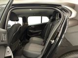 the interior of a car with the door open showing the driver ' s seat area