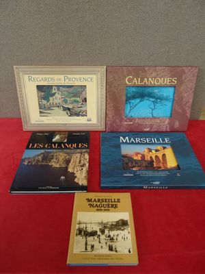 trois livres posés sur une table recouverte d'une nappe rouge et d'une nappe rouge