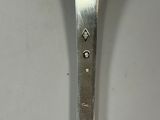 a silver spoon with a silver handle on a white table