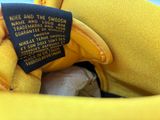 a close up of a yellow bag with a label on it