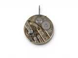 a close up of a watch movement on a white surface