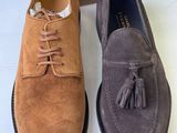 a pair of men ' s sued shoes with tassels on them