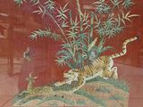 a picture of a painting of a tiger and a deer in the grass