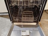 an open dishwasher that is sitting on the floor