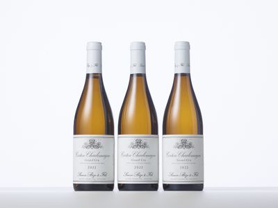 three bottles of white wine sitting on top of a table