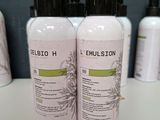 two bottles of lotion sitting on top of a counter next to each other