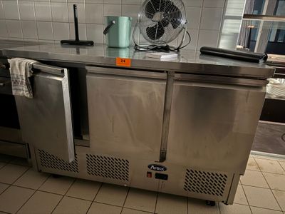 a stainless steel counter with a fan on top of it