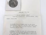 an image of a piece of paper with a piece of coin on it