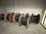 many spools of different sizes and colors in a warehouse