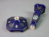 a small blue box with a clock on it next to a smaller blue box