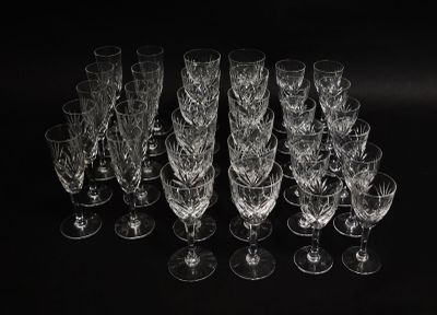 a lot of empty wine glasses on a black table