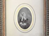 an old picture of a woman in a white dress and a black and white picture of a man