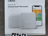 a white box with a phone and a smart thermosta on top of it