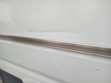 a close up of the door of a white van