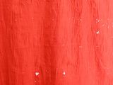 a red cloth with white spots on it