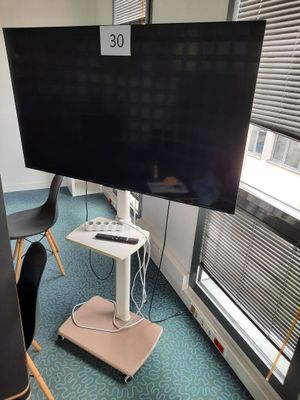 a flat screen tv on a stand in a room