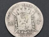a close up of a silver coin with a crown on it