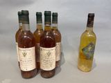 three bottles of wine and a bottle of wine sitting on a table