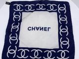 a white plate with a blue and white cake with a name on it