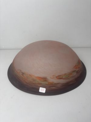 a brown and white bowl on a white surface