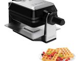 a close up of a waffle maker next to a plate of waffles