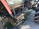 a tractor that is parked on the side of the road