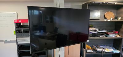 a large flat screen tv sitting on a stand in a room