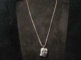 a necklace with a silver elephant pendant on a mannequin