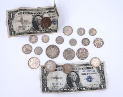a lot of coins and a dollar sitting on a table