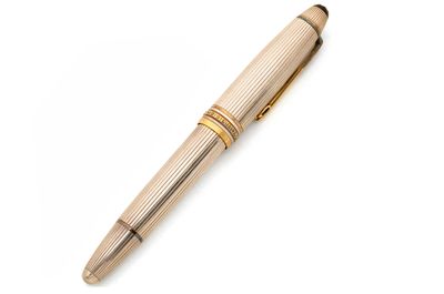 un gros plan d'un stylo posé sur une surface blanche
