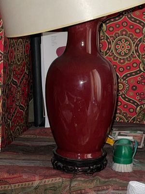 a lamp that is sitting on a table next to a curtain