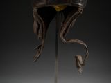 an image of a helmet on a stand on a black background