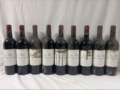 several bottles of wine are lined up on a table