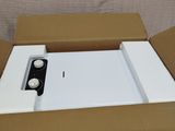 a box with a phone inside of it sitting on a couch
