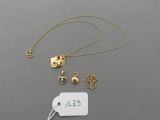 a close up of a necklace with a tag on a table