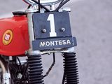 a red motorcycle parked on the side of the road