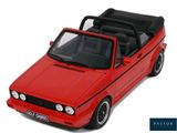 a red toy car with a black top on a white background