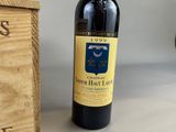 a bottle of wine sitting next to a wooden box