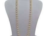 a close up of a necklace on a mannequin with a white background
