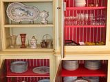 a china cabinet with dishes and plates in it