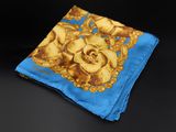 a close up of a blue and yellow handkerchief on a black surface