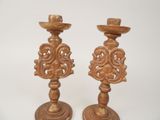 two wooden candlesticks that are sitting next to each other