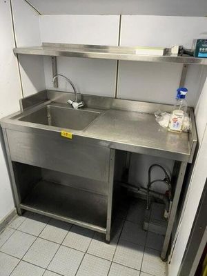 a kitchen with a sink and a counter in it