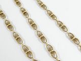 a close up of a gold chain on a white background